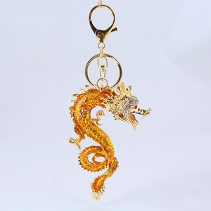 Golden Chinese dragon keychain with yellow enamel and sparkling crystal accents