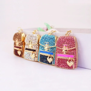 Glittering rhinestone backpack keychains in four colors with gold heart pendants