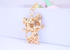 Detailed macro view of the golden cat keychain with hollowed heart pattern design