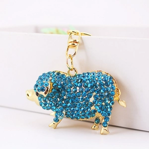 Porte-clés cochon doré orné de cristaux bleus brillants avec fermoir mousqueton chic