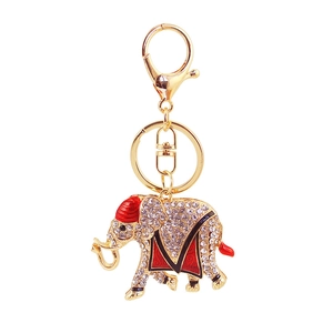 Portachiavi a elefante con strass bianchi, sella in smalto rosso e finitura dorata lucida