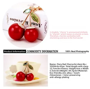 Detailed view of red cherry keychain with green rhinestones and dimensions shown