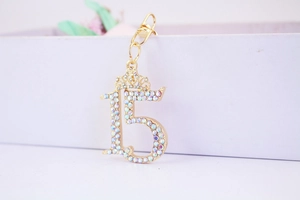 Detail of crystal number 15 crown keychain with colorful rhinestones and gold lobster clasp