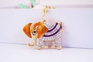 Close-up of golden elephant keychain with sparkling rhinestones and colorful enamel details