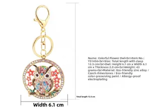 Detailed close-up of a colorful crystal owl keychain with red enamel flowers
