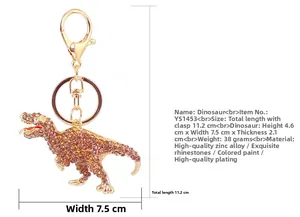 Macro shot of rhinestone dinosaur keychain showing 11.2cm total length and dimensions