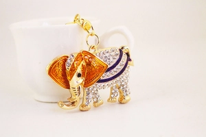 Close-up of golden elephant keychain with sparkling rhinestones and orange enamel details