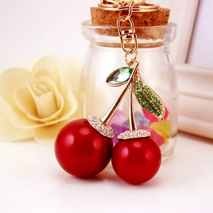 Sparkling red cherry keychain with green rhinestone leaves and gold lobster clasp