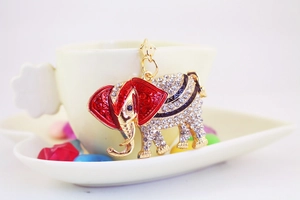 Detailed close-up of a golden elephant keychain with sparkling crystals and red enamel