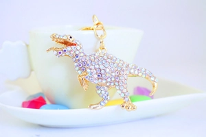 Detail of crystal dinosaur keychain with AB rhinestones and golden lobster clasp