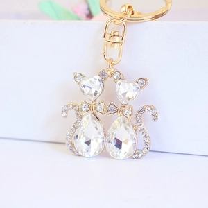 Creative cute cat couple keychain with golden alloy and sparkling crystals on white box