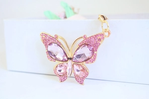 Close-up of pink crystal butterfly keychain with rhinestones and gold plating