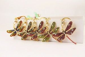 Detailed view of colorful rhinestone dragonfly keychains in various gradient colors