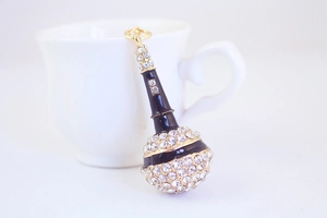 Macro view of crystal encrusted black and gold microphone keychain with sparkling rhinestones