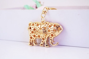 Exquisite hollowed-out golden elephant keychain with intricate metal craftsmanship