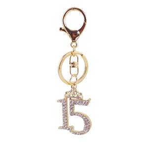 Golden number 15 keychain with a crystal crown pendant on a polished ring for bags