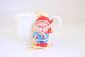 Detail of Santa Claus keychain with colorful enamel and sparkling rhinestones