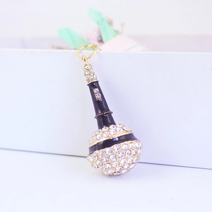 Sparkling crystal microphone keychain with gold metal plating and black enamel details