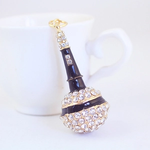 Elegant black microphone keychain with sparkling white rhinestones on a white background