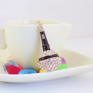Sparkling black microphone keychain with clear rhinestones on a white ceramic mug