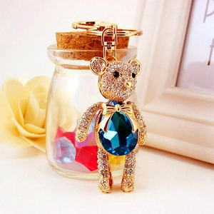 Golden teddy bear keychain with crystal diamonds and blue gemstone for bags