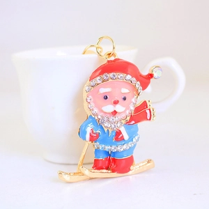 Creative Christmas Santa Claus keychain in gold metal with rhinestones on white cup