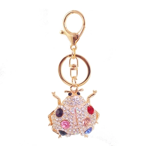 Sparkling rhinestone ladybug keychain with colorful gemstones and golden metal hardware