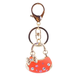 Süßer orangefarbener Handtaschen-Schlüsselanhänger mit goldener Schleife und Kristallen