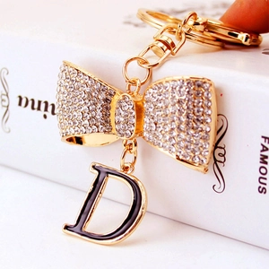 Mignon Porte-clés Lettre D Avec Nœud En Strass Or Alliage De Zinc Charme De Sac Bijoux De Mode Étincelants Pour Femme Cadeau