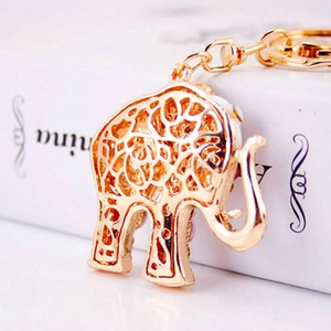Golden elephant evil eye keychain featuring intricate hollow patterns and vibrant crystal drop oil