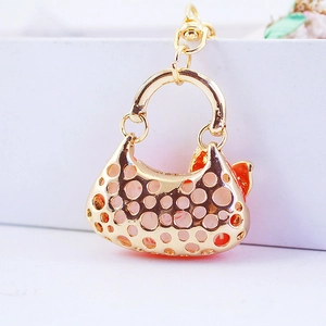 Süßer goldener Handtaschen-Schlüsselanhänger mit Lochmuster und Karabiner für Damen