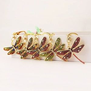 Creative dragonfly keychains with colorful rhinestones on a gold metal base and hooks