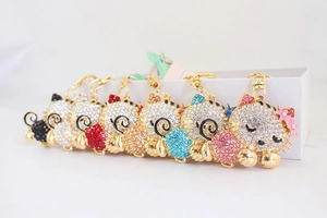 Close-up detail of rhinestone encrusted cat keychains in various vibrant colors