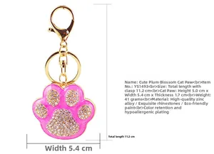 Detail of pink rhinestone cat paw keychain with gold spring buckle and zinc alloy