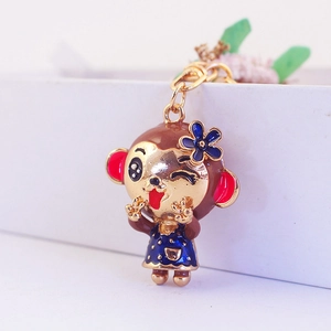 Cute cartoon female monkey keychain pendant with floral accents and gold-plated finish
