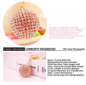 Macro detail of gold crystal ball keychain showing clear rhinestones and lobster clasp