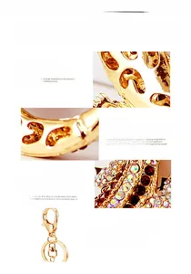 Macro detail of gold lizard keychain with colorful rhinestones and lobster clasp hardware