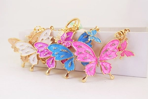 Close-up of colorful butterfly keychains with rhinestones in a white gift box