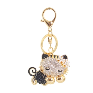 Sparkling rhinestone kitten keychain in gold alloy with floral details and lobster clasp