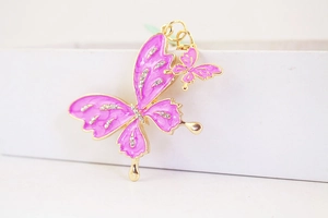 Macro shot of pink rhinestone butterfly charms with gold alloy plating for keychains