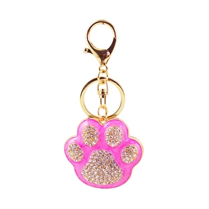 Sparkling pink rhinestone pet paw print keychain with a polished gold alloy frame