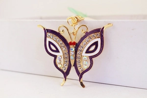 Close-up of butterfly keychain with purple enamel and sparkling white rhinestones
