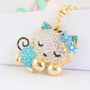 Sparkly crystal cat keychain with blue enamel flowers in polished gold finish