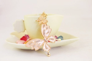 Detailed close-up of pink enamel double butterfly keychain with sparkling rhinestones