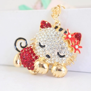 Cute kitten keychain with white and red rhinestones on a gold-plated flower cat pendant