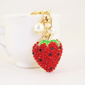 Sparkling rhinestone strawberry keychain with white pearls and gold metal clip charm