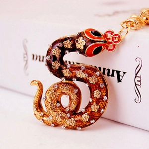 Sparkling rhinestone snake keychain with gold metal base and red head for bags