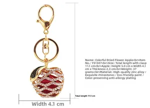Detailed view of rhinestone apple keychain with gold alloy frame and crystal inlay