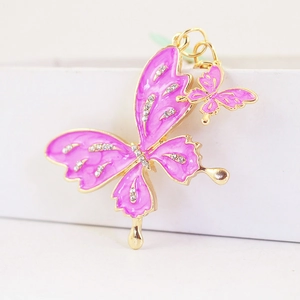 Charming pink enamel butterfly keychain with sparkling rhinestones and gold droplets
