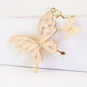 Sparkling rhinestone butterfly keychain with cream orange enamel and gold metal plating